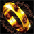 A pixelated golden ring with reflective highlights on a dark background, rendered in a low-resolution style with visible pixelation.