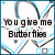 A pixelated animation of a blue and black butterfly pattern with text reading "You give me Butterflies" that fades out over