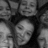 Black-and-white group photo of multiple people with blue pixelated text overlay reading 'my friends may be crazy but i luv them anyway'.