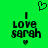 Green background with black pixelated text reading "I LOVE sarah" and two heart symbols, one above and one below the text.