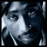 Pixelated grayscale image of a stylized face with abstract shapes and high contrast, appearing to be a low-resolution icon or logo.