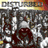 A hooded figure with glowing eyes and a wide grin appears in a pixelated crowd scene, with a close-up view of the figure's face.