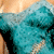 A 2x2 contact sheet of four animated frames showing a woman in a teal dress with curly hair, displayed as an AIM buddy icon.