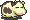 Two pixelated avocado halves with brown pits, pink cheeks, and closed eyes on a gray background; right half shows motion blur.
