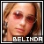 Pixelated close-up of a person with light brown hair and red eyes, featuring bold white text reading BELINDA at the bottom.