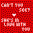 Red background with black dots, white pixelated text reading "CAN'T YOU SEE? SHE'S IN LOVE WITH YOU" and a small heart symbol above the word "SEE?", displayed in three