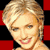 Static pixelated image of a smiling woman with short blonde hair against red and black background squares.