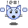 Pixelated blue cat face with pink cheeks, black eyes and nose, white ear tips, gray whiskers, two light-blue squares on sides, dark-gray shadow below, !@#! text above.
