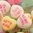 Four quadrants display heart-shaped candies with red text and a 'Happy Valentines Day' message in bold black letters.