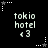 Pixelated text 'tokio hotel <3' repeated in a with alternating star icons, set against a black background