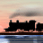 Silhouette of a steam locomotive with smokestacks and tender against a gradient sky transitioning from peach to gray, reflected in water below.