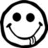 Black and white pixelated smiley face with large circular eyes, a curved mouth, and a small tongue sticking out from the lower right side of its mouth.