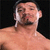 Pixelated image of a shirtless man with short dark hair and facial stubble, next to pixelated text reading "TRUE WWE CHAMP" on a gray background.