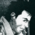 Pixelated grayscale image of a stylized figure with a rounded head and cylindrical body against a dark background.