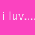 Pixelated image of a woman with long brown hair and blue eyes, wearing a pink top under a bright pink background with text.