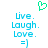 Green pixelated heart symbol above blue text reading 'Live. Laugh. Love.' and a smiley face emoticon on white background.