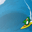 Pixelated image of a green penguin surfing on a yellow board under a blue wave with white spray, against solid cyan background.