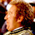 Pixelated static image of a person's profile with curly hair and warm lighting, likely from a movie or character reference.