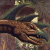 A pixelated static image shows a brown, reptilian creature with a long snout and dark eyes, partially obscured by a dark blue headpiece against a muted background.