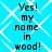 Blue background with white geometric pattern and repeated black text reading 'Yes! my name in wood!' in pixelated font.