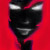 A pixelated face with glowing white eyes and a wide grin against a solid red background.