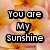 Pixelated text "You are My Sunshine" in white block letters with black outlines on a blurred orange and pink background.