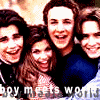 Four people pose closely together in a pixelated group photo with a light brown background and partially visible text at the bottom.