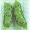 Two green pea pods with smiling faces, each containing multiple round green peas with simple black eyes and red mouths, set against a light grid background.