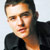 Static 50x50 pixel buddy icon showing a close-up of a person's face with dark hair and black clothing against a light background.