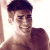 Pixelated image of a person with short dark hair and light skin, wearing no shirt, positioned next to green text reading 'Original Icons .com' on a solid background.