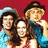 Three people pose together against a red background with orange text reading "Dukes of hazzard" and "Luke Best Dasiy show Bo ever!!!".