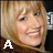 nine shows a person with blonde hair and bangs, smiling in various poses against a dark background with repeating patterns