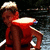 A person in a red life vest and light cap stands on water, with yellow text overlay appearing in one frame.