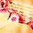 Pixelated static image of abstract floral or organic shapes in warm tones on a light background.