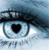 Pixelated eye icon with black pupil and eyelid, blue-gray gradient background, and faint text below the eye.