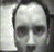 A black-and-white animated sequence showing a person's face in three distinct expressions: neutral, squinting eyes with mouth closed, and wide-eyed with open mouth.