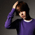 A person in a purple long-sleeve shirt with white collar stands against a gray background, hand on head, expression shifting across frames.