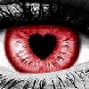 A close-up of a human eye with a red iris and a black heart-shaped pupil, surrounded by visible eyelashes and a dark upper eyelid.