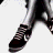 Pixelated black-and-white image showing a person's lower legs and feet in motion with text reading "Converse are Sexy" on the right side.