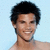 Pixelated portrait of a smiling person with short dark hair against light blue background, cropped at shoulders.