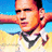 Pixelated image of a person with short dark hair wearing a white shirt and black neckerchief against blue sky and yellow ground background.