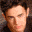 Two distinct human faces in separate , one with closed eyes and the other with open eyes, both rendered in pixelated style