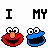 Pixelated icons of Elmo and Cookie Monster alternate with 'I MY I' text , featuring a heart symbol replacing 'LOVE' in one