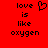 Red background with black pixelated text reading 'love is like oxygen' and a heart symbol, displayed in two identical side-by-side
