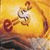 A pixelated static image shows a stylized figure with a white torso and brown limbs against a yellow-orange gradient background with dark lower tones.