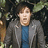 Pixelated image of a person in a gray jacket and blue shirt against green foliage, with white pixel text on solid blue background reading "Somebody stole his cookies!".