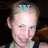 A person with light hair in a dark sleeveless top appears in three with blue text overlays reading IN, LOVING, and MEMORY