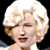 Two side-by-side frames of a pixelated animated icon showing a blonde woman with curly hair in different facial expressions against black backgrounds.