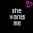 Pixelated text 'she wants me' in white on black background with pink heart symbol above, two identical side-by-side versions of the text layout.