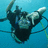 Pixelated underwater scene with a diver in scuba gear and red text reading KEVIN IS MY BITCH on black background.